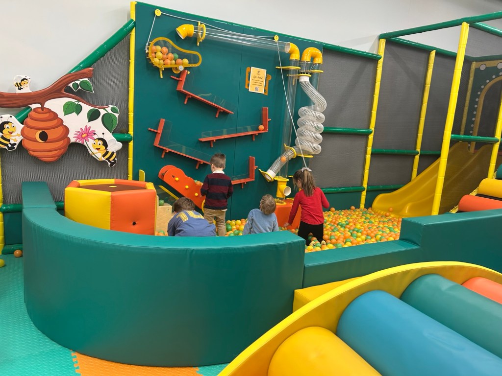 Young children play with wall ball ramps and air flow at Kids Play Hive
